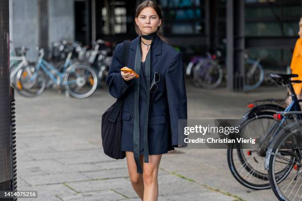 Guest is seen wearing navy oversized blazer outside Remain during Copenhagen Fashion Week Spring/Summer 2023 on August 09, 2022 in Copenhagen,...