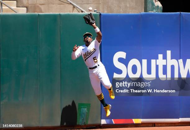 Tony Kemp of the Oakland Athletics makes a leaping catch at the wall to take a hit away from Shohei Ohtani of the Los Angeles Angels in the top of...