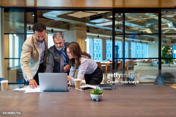 business team working on a laptop computer. - meeting candid office suit stock pictures, royalty-free photos & images