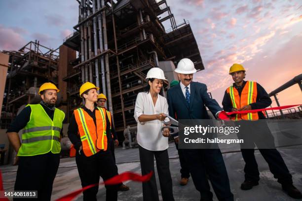 managers or politicians cutting ribbon at power plant - cortar a fita imagens e fotografias de stock