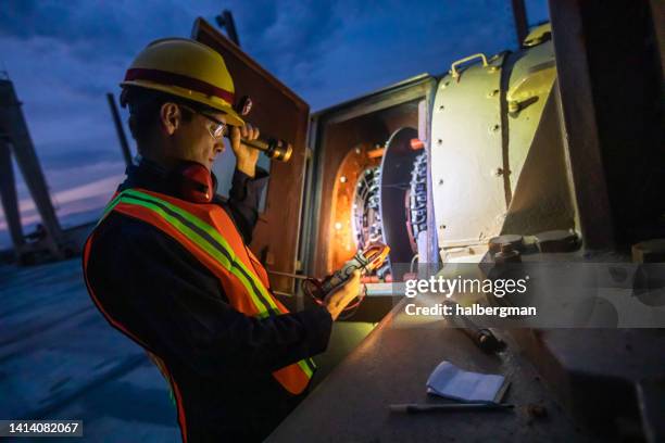 electrical engineer working at power plant at night - hoofdlamp stockfoto's en -beelden