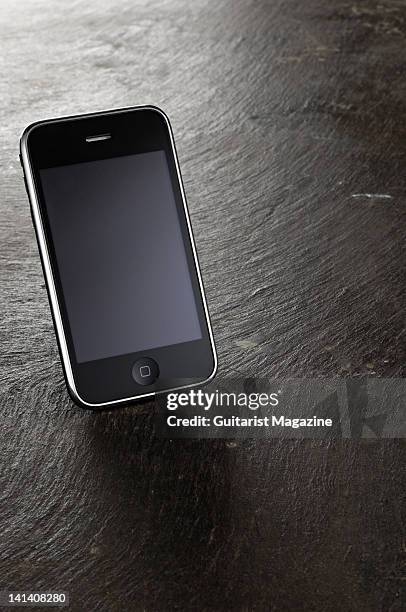 An Apple iPhone 3G resting on a large slate, during a studio shoot for Guitarist Magazine/Future via Getty Images, March 10, 2010.