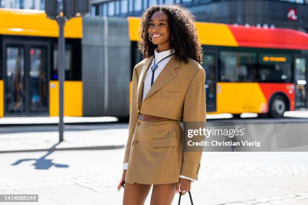 Cheyenne Maya Carty seen wearing beige cropped blazer, wrapped skirt, Prada necklace, bag , white button shirt, socks, Prada shoes outside Holzweiler...