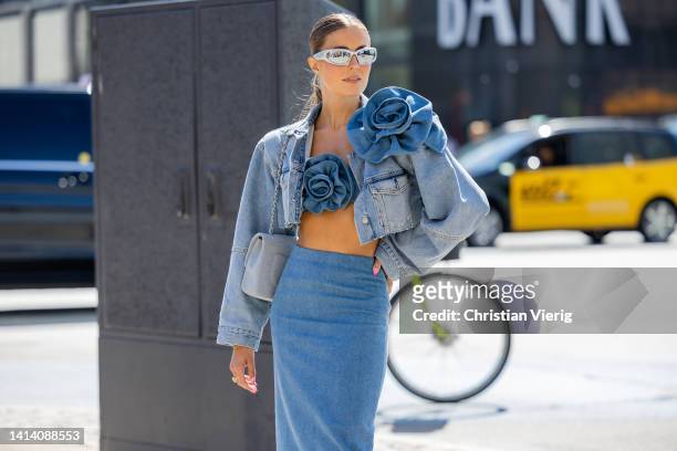 Nina Sandbech seen wearing cropped denim jacket, bustier, high waisted denim skirt outside Holzweiler during Copenhagen Fashion Week Spring/Summer...