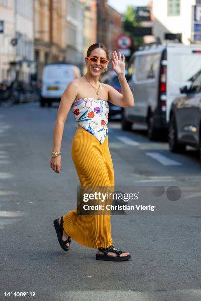 Idalia Salsamendi is seen wearing Top: rotate, yellow Skirt: Malene Birger, Shoes: Prada, Jewelry: Annoushka, Sunglasses: Jimmy Fairly during...
