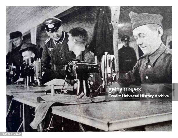 Prisoners making gloves in a German prisoner of war camp during World War II.