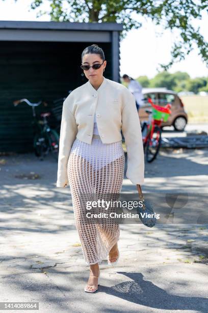 Guest is seen wearing net skirt outside Samsøe Samsøe during Copenhagen Fashion Week Spring/Summer 2023 on August 10, 2022 in Copenhagen, Denmark.