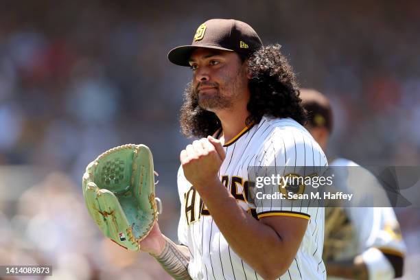 Sean Manaea of the San Diego Padres returns to the dugout during the third inning of a game against the San Francisco Giants at PETCO Park on August...