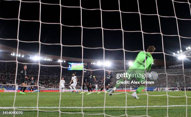 General view as Karim Benzema of Real Madrid scores their side's second goal as Kevin Trapp of Eintracht Frankfurt attempts to make a save during the...