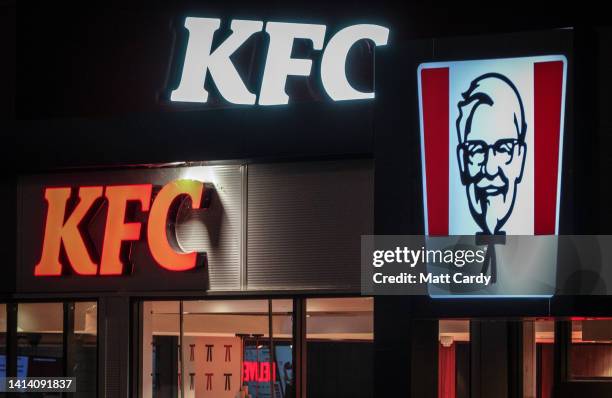 The KFC logo is illuminated outside a branch of the fast food outlet KFC on August 28, 2022 in Glastonbury, England.