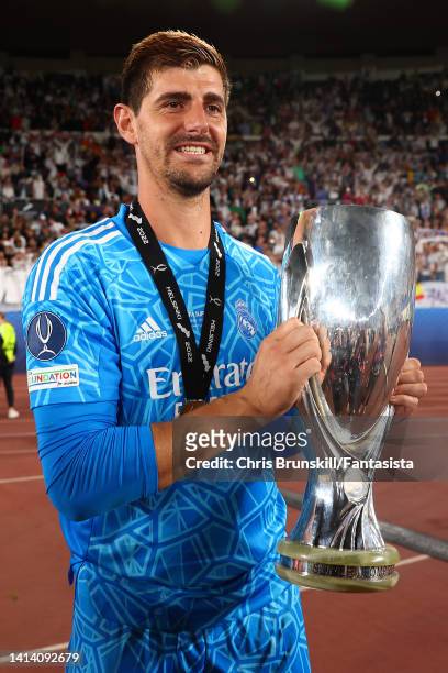 Thibaut Courtois of Real Madrid celebrates with the trophy following the Real Madrid CF v Eintracht Frankfurt - UEFA Super Cup Final 2022 at Helsinki...