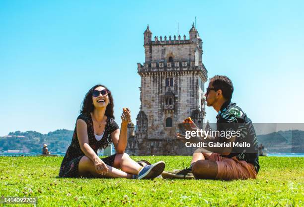 friends sitting on grass eating a pastel de nata - lisbon food stock pictures, royalty-free photos & images