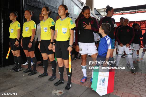 Kinberly Guzman of Mexico speaks with a mascot before playing against New Zealand at Alejandro Morera Soto on August 10, 2022 in Alajuela, Costa Rica.