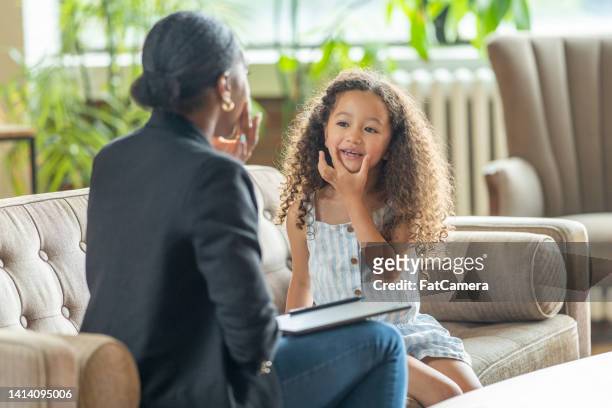 speech therapist working with a little girl - word of mouth stock pictures, royalty-free photos & images