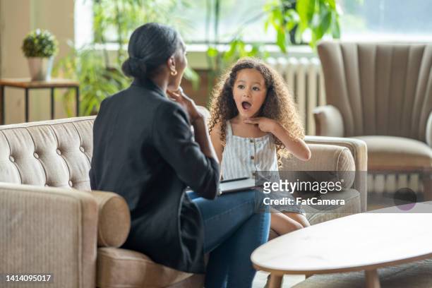 speech therapist working with a little girl - word of mouth stock pictures, royalty-free photos & images