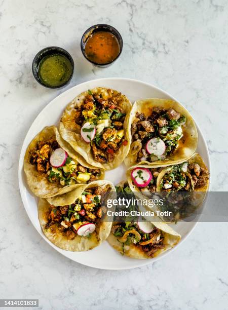 plate of street tacos with salsa on white background - mexican food background stock pictures, royalty-free photos & images