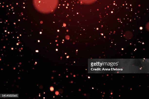 glittering red particles on black isolated background - レンズフレア　黒バック ストックフォトと画像
