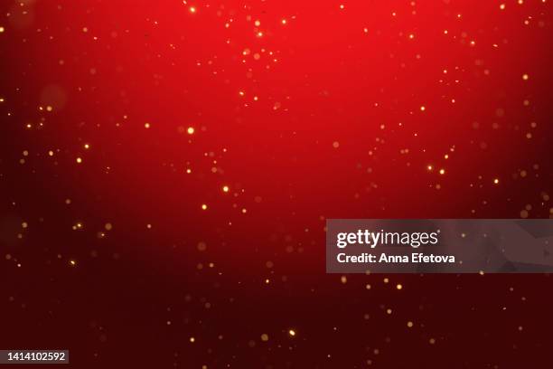 many blurred bright confetti on red gradient background. festive colorful backdrop for your design. merry christmas and happy new year - red gold party stock-fotos und bilder