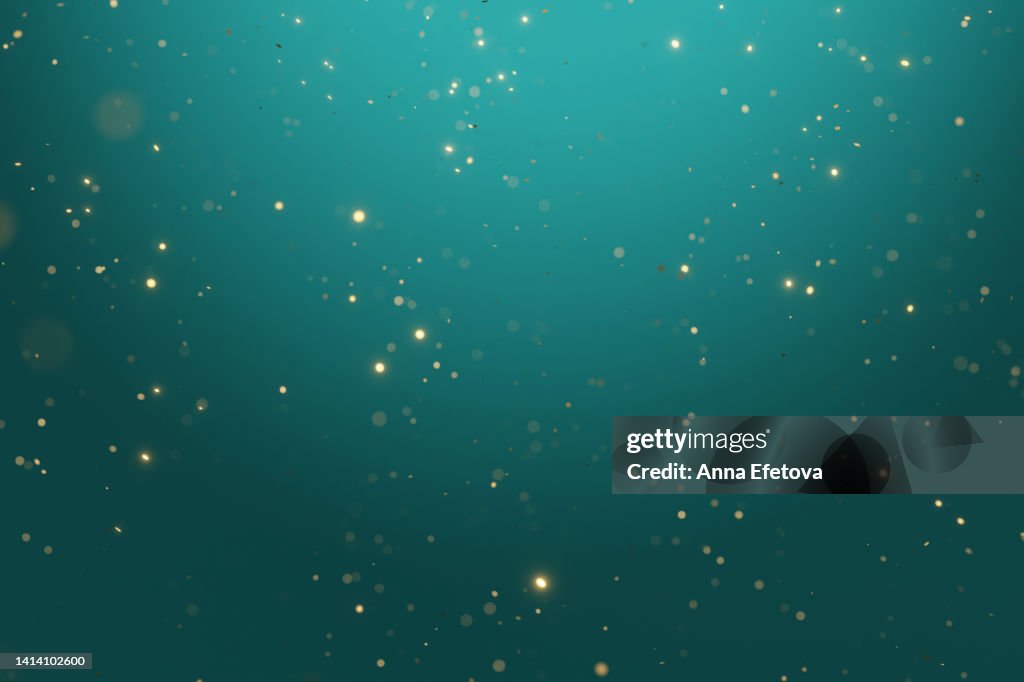 Many blurred bright confetti on turquoise gradient background. Festive colorful backdrop for your design