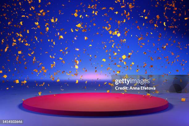 red podium on blue background with many flying golden confetti. festive place for your products presentation. copy space for your design - star burst imagens e fotografias de stock