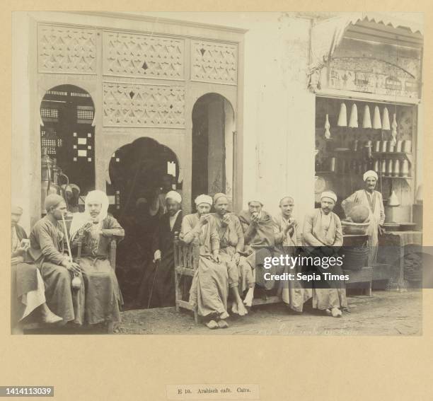 An Arabian cafe in Cairo, 10. Arab cafe. Cairo. Egypt 654 Cafe Arabe au boire. Men drinking coffee outside. The photograph is part of the series of...