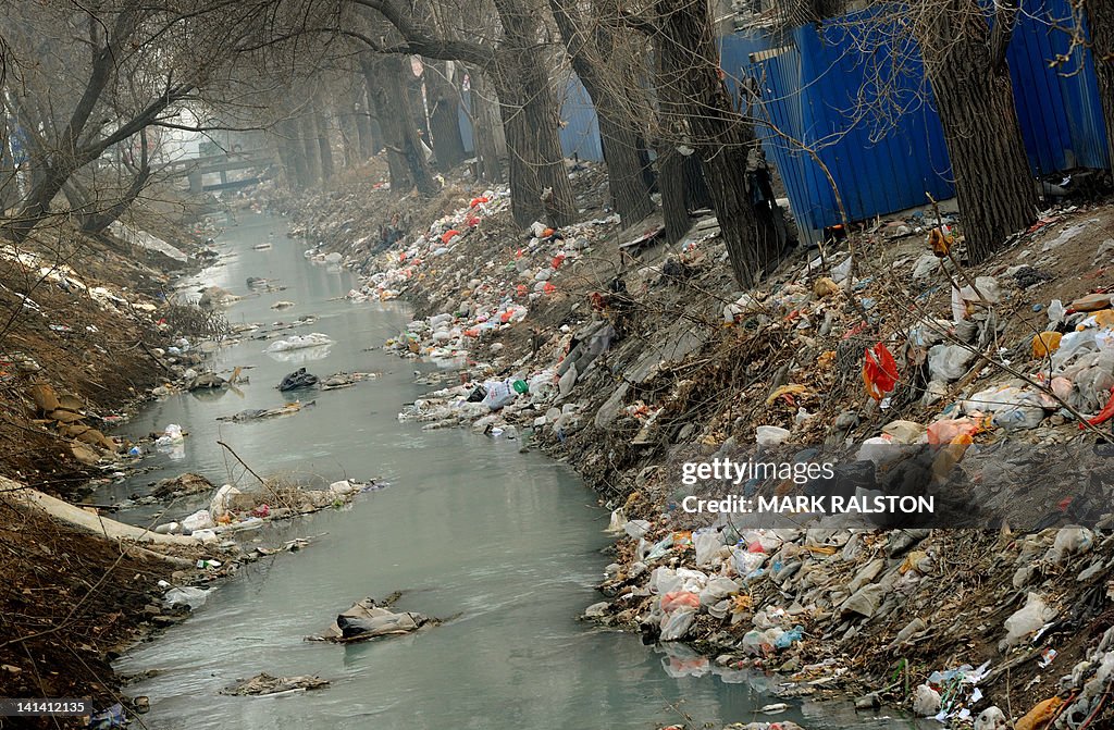 Trash clogs up a polluted canal at the e