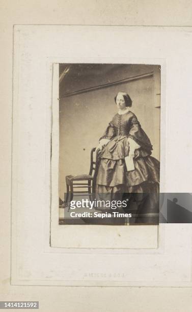 Portrait of a woman in a long dress holding paper, Part of Photo Album with 48 cartes-de-visite presented to Marshal Count De Castellane. Anonymous,...