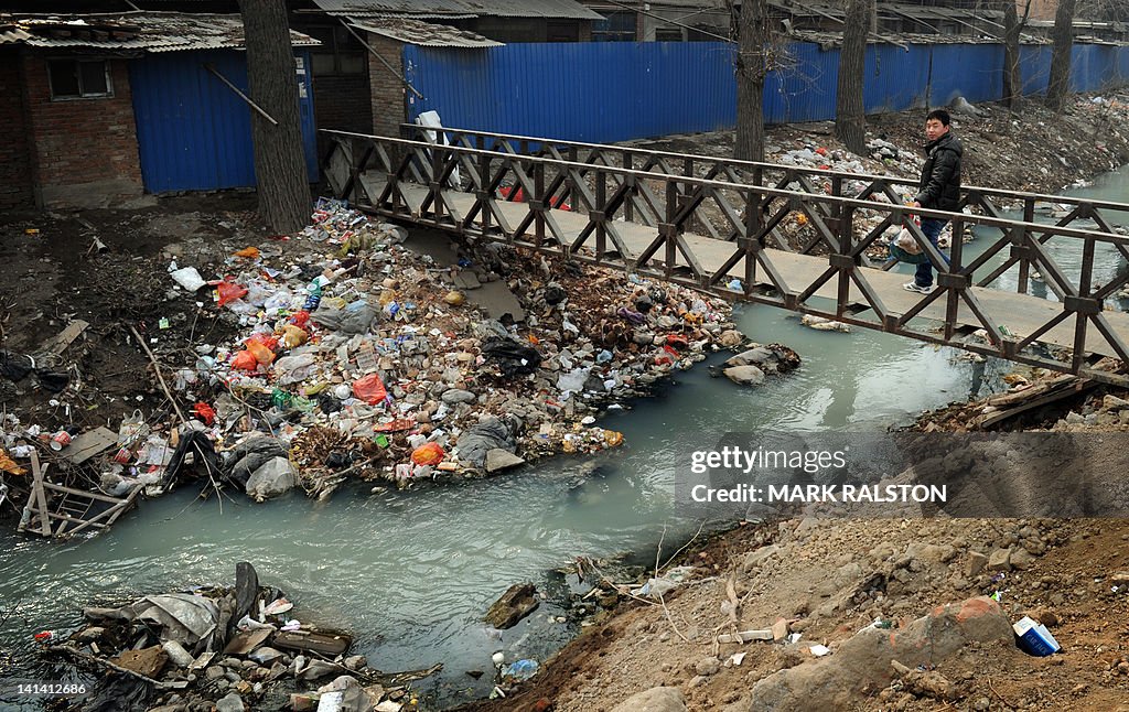 Trash clogs up a polluted canal at the e