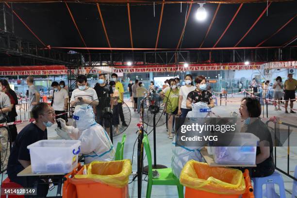 People queue up for COVID-19 nucleic acid tests on August 10, 2022 in Xiamen, Fujian Province of China.