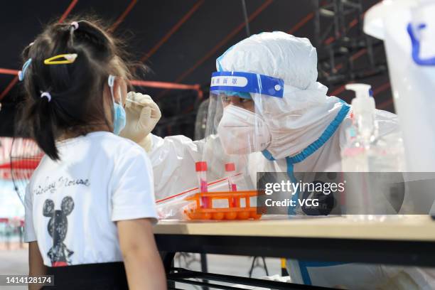 People queue up for COVID-19 nucleic acid tests on August 10, 2022 in Xiamen, Fujian Province of China.