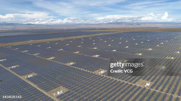 Aerial view of solar panels at a photovoltaic park on August 10, 2022 in Gonghe County, Hainan Tibetan Autonomous Prefecture, Qinghai Province of...