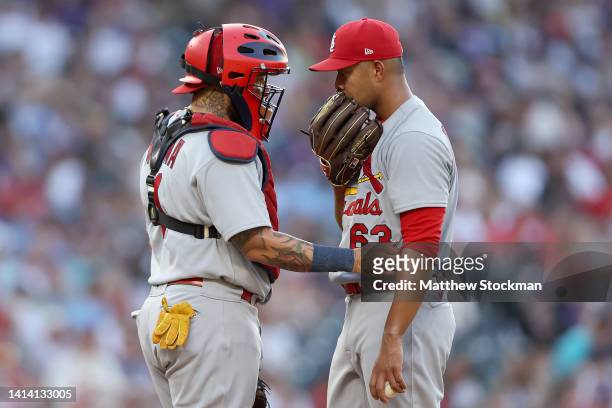 Catcher Yadier Molina and starting pitcher Jose Quintana of the St Louis Cardinals confer on the mound while playing the Colorado Rockies in the...