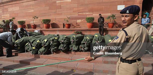 Security personnel check bundles of budget papers outside the Indian Parliament in New Delhi, India, on Friday, March 16, 2012. India's economy is...