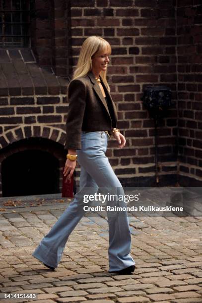 Jeanet Madsen wearing blue jeans, black top and brown crop jacket posing outside A. Roege Hove show during Copenhagen Fashion Week Spring/Summer...