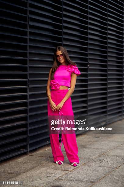 Nina Sandbech wearing pink pants, pink top and pink bag posing outside Remain show during Copenhagen Fashion Week Spring/Summer 2023 on August 09,...