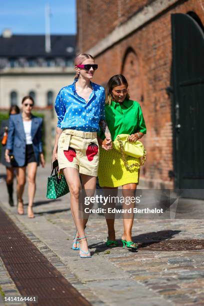 Marianne Theodorsen wears black plastic and purple velvet sunglasses from Chanel, multicolored earrings, a blue with white polka dots print pattern...