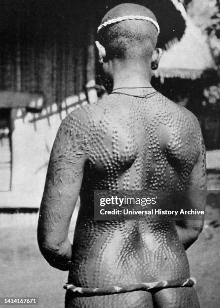 Scarifying the skin as a permanent body modification, Cameroon, West Africa c1930. Scarification is sometimes called cicatrisation .