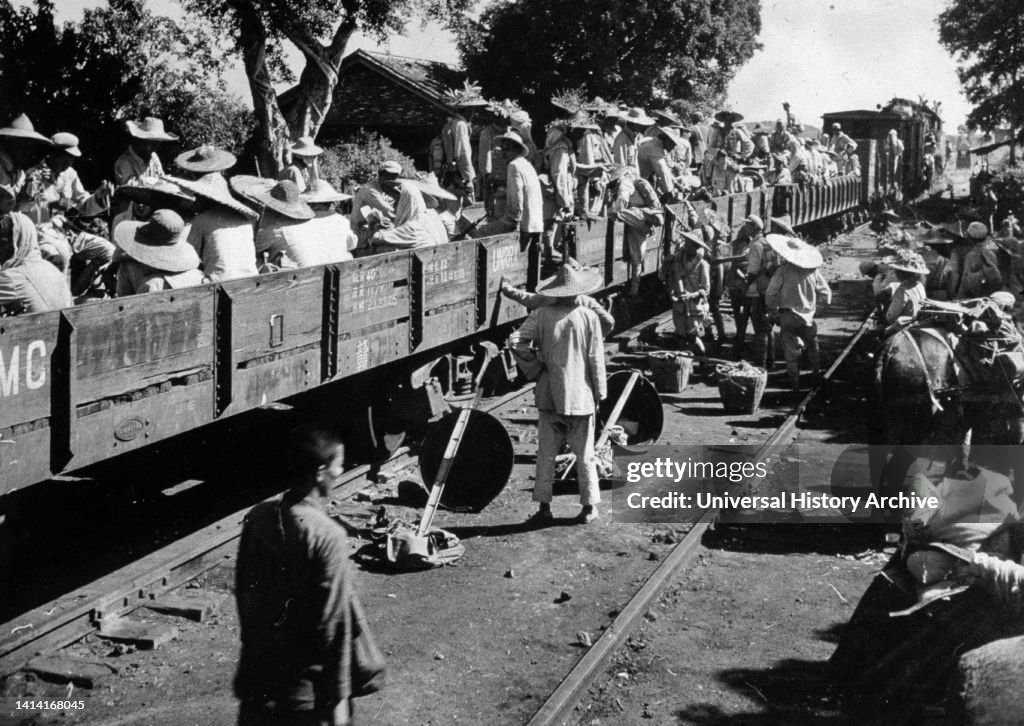 Chinese communist irregular forces boarding train cars near the Kwangtung-Kwangsi border