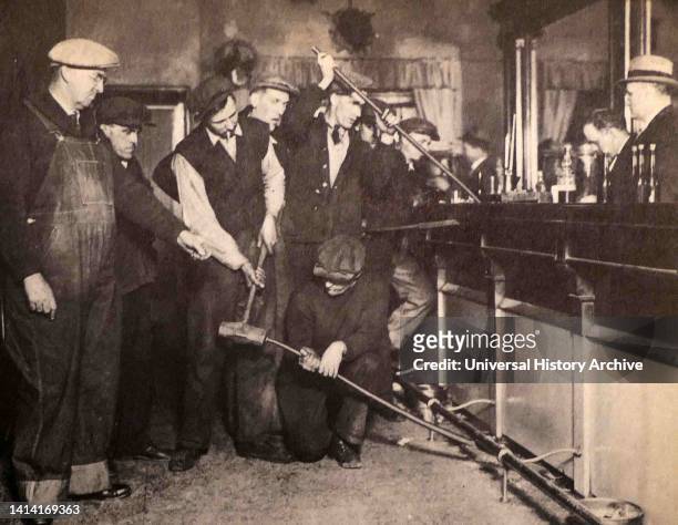 Violation of the Prohibition law in America. A bar in a cafe is pried up in Camden, New Jersey, USA.