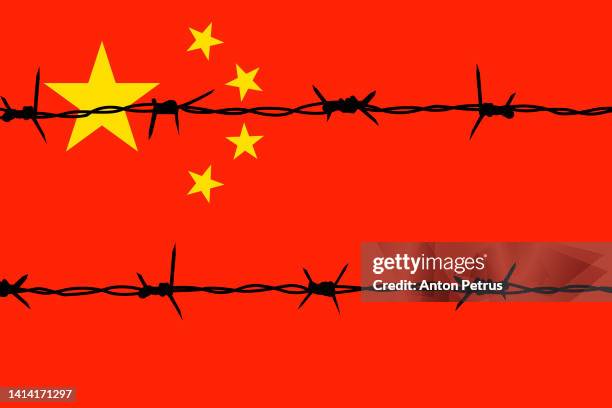 barbed wire on the background of the chinese flag - fil barbelé photos et images de collection