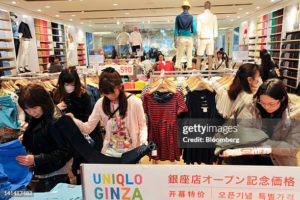 Customers browse inside Fast Retailing Co.'s Uniqlo store in the Ginza district of Tokyo, Japan, on Friday, March 16, 2012. Fast Retailing Co., the...