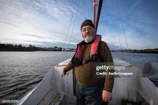 a sailorman from brittany in france  stands on his boat - brittany france stock pictures, royalty-free photos & images