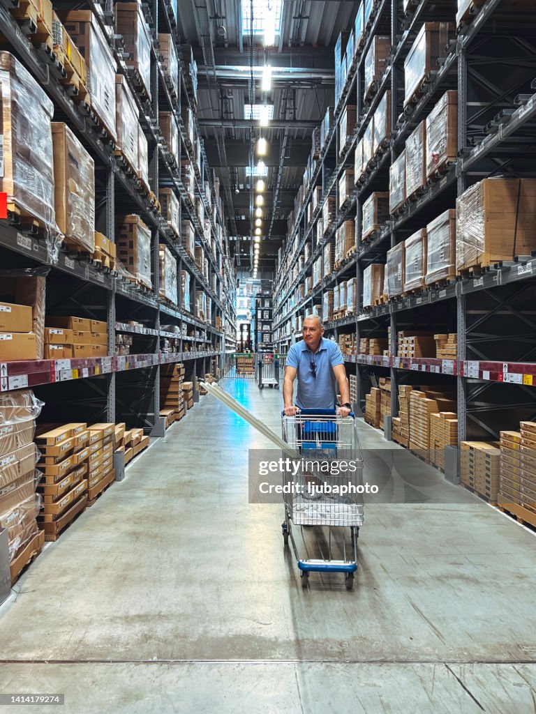 Man in Big Box Store Shopping with Cart