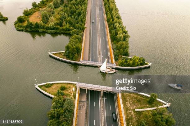 aquaduct veluwemeer in the veluwe lake with a boat sailing in the canal - aqueduct stockfoto's en -beelden