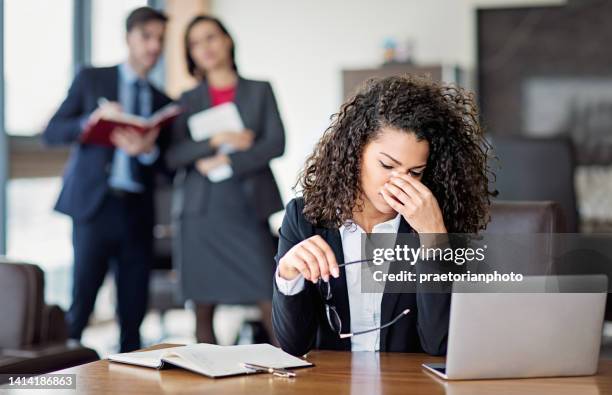 portrait of burnout businesswoman in an office - harassment work stockfoto's en -beelden