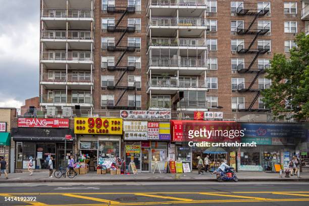 chinese shops and a residential building - flushing queens stock pictures, royalty-free photos & images