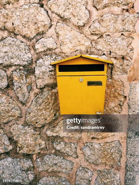 close-up of a yellow mailbox hanging on a wall, majorca, spain - buzones fotografías e imágenes de stock