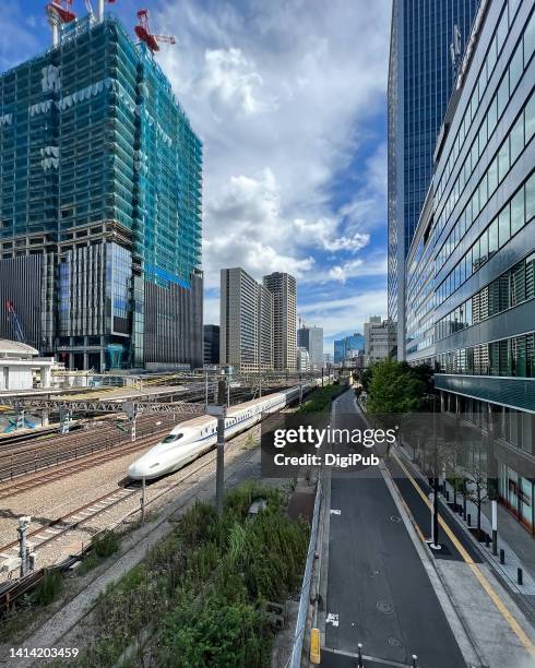 shinkansen train passing by tamachi station - n700s stock pictures, royalty-free photos & images