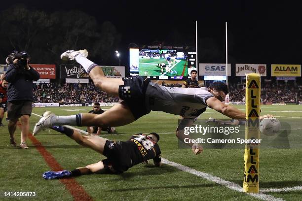 Xavier Coates of the Storm attempts to score a try during the round 22 NRL match between the Penrith Panthers and the Melbourne Storm at BlueBet...