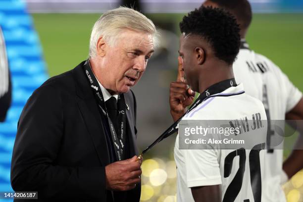 Carlo Ancelotti, Head Coach of Real Madrid, chats with Vinicius Junior after the UEFA Super Cup Final 2022 between Real Madrid CF and Eintracht...